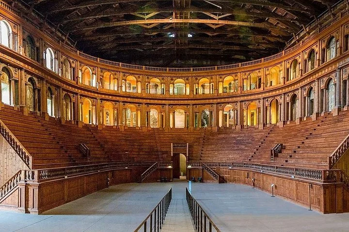 The vast wooden Teatro Farnese in Parma with its tiered seating and arcades under a timbered ceiling
